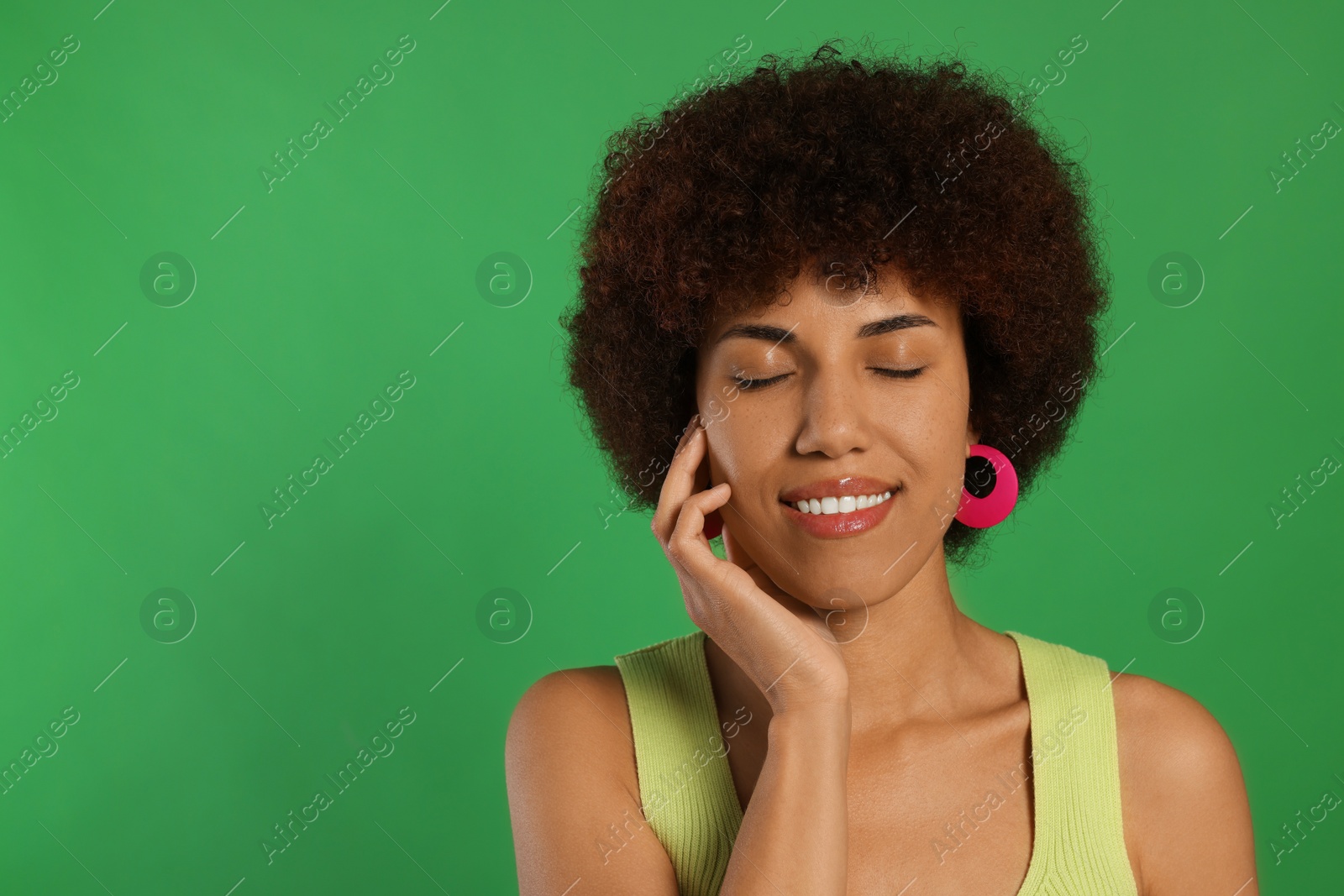 Photo of Portrait of happy young woman on green background. Space for text