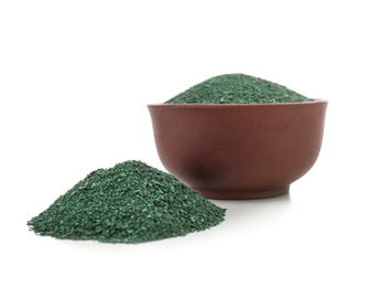 Photo of Heap and bowl of spirulina algae powder isolated on white