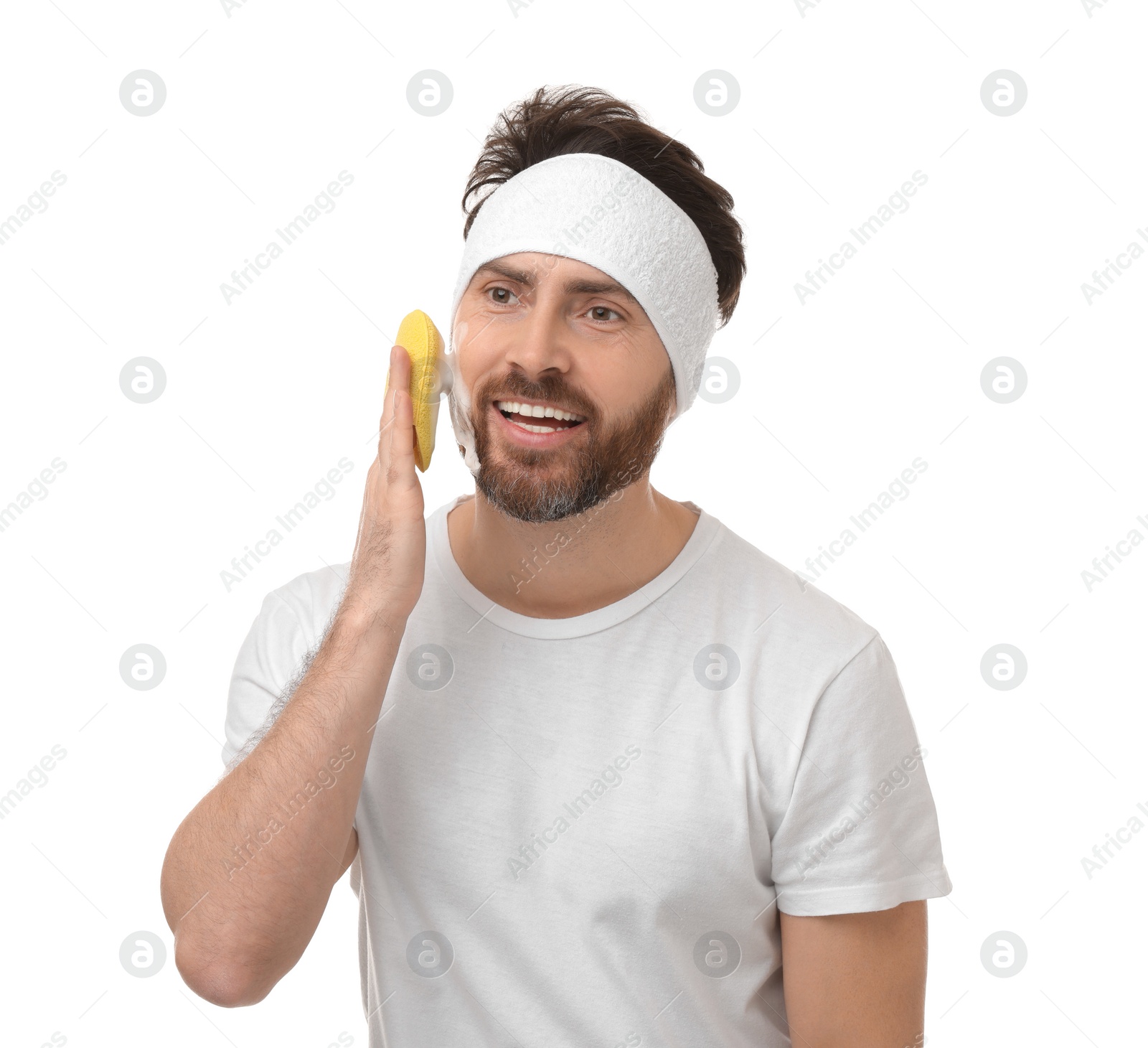 Photo of Man with headband washing his face using sponge on white background