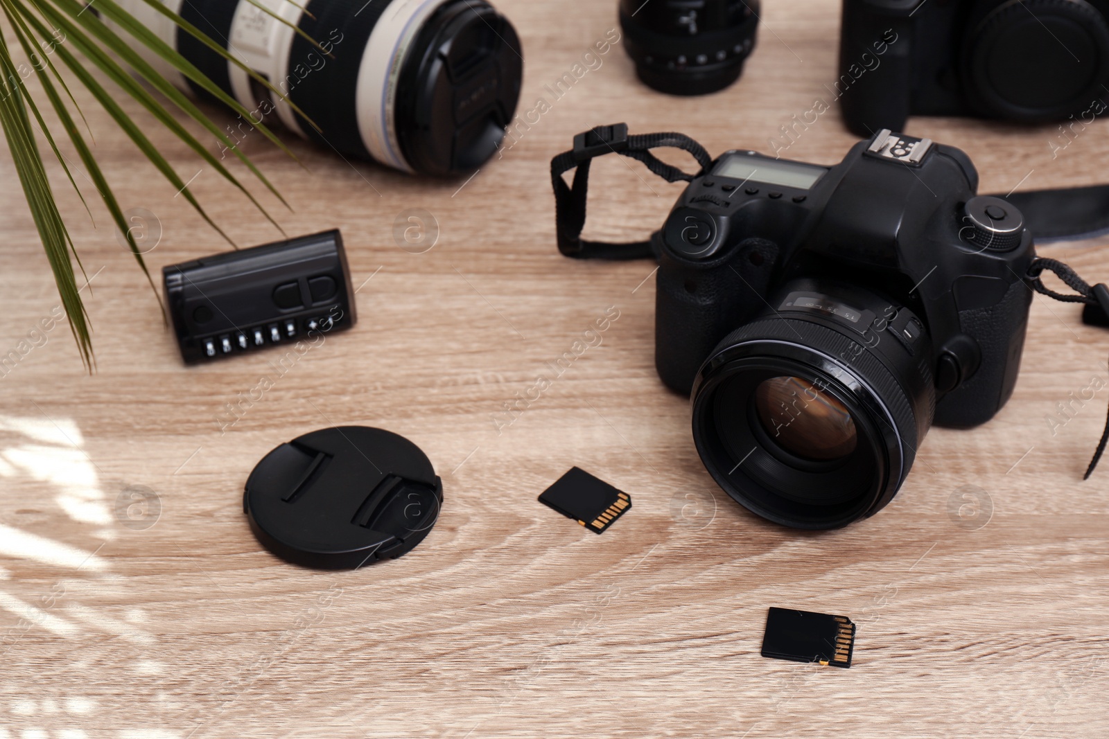 Photo of Set of professional photographer's equipment on wooden table