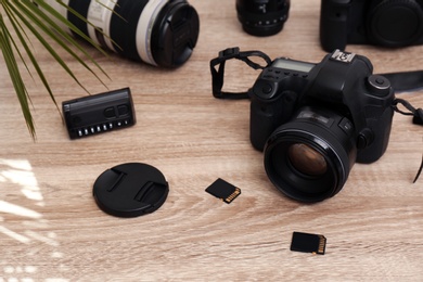 Set of professional photographer's equipment on wooden table