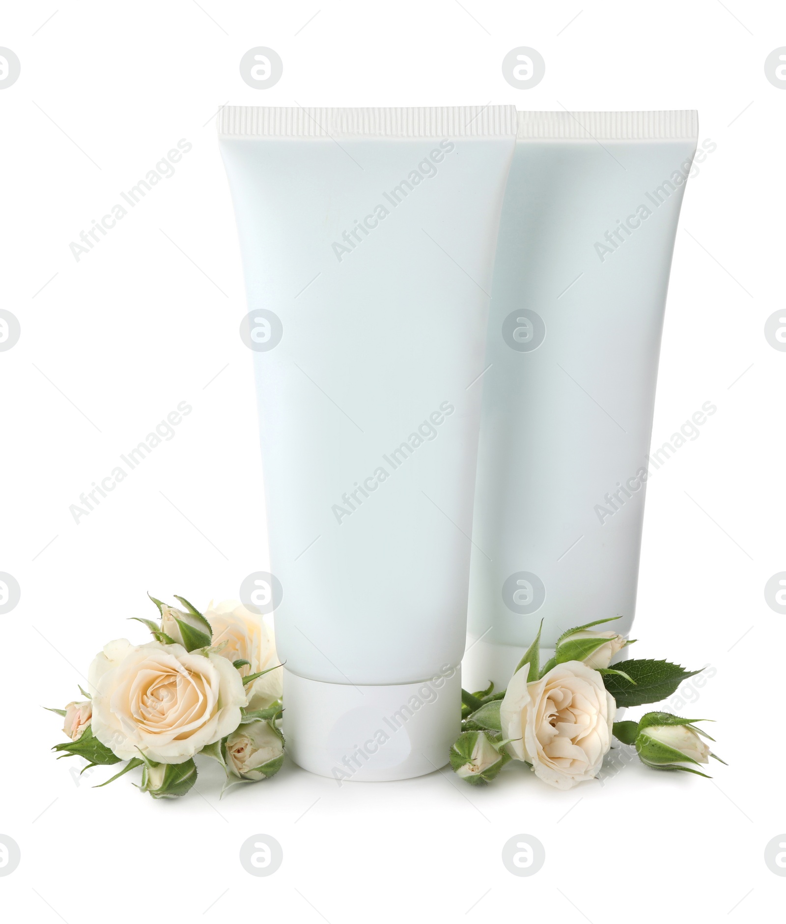 Photo of Tubes of hand cream and roses on white background