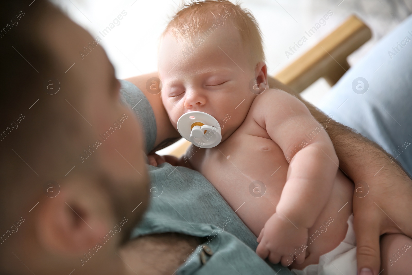 Photo of Father with his newborn son, above view