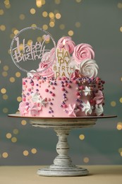 Beautiful birthday cake with festive decor and candle on white table