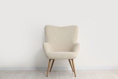 Photo of Comfortable armchair near white wall in room