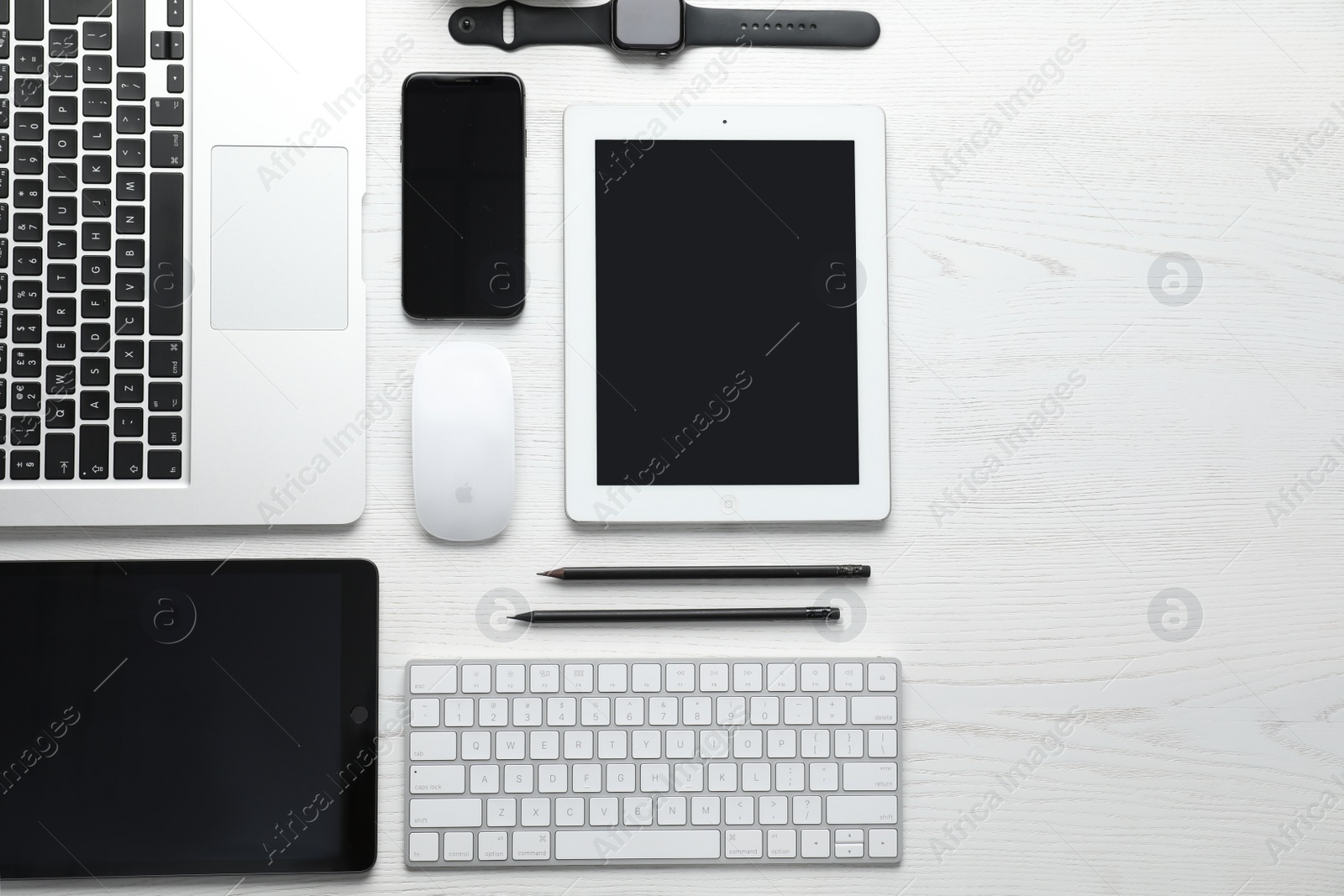 Photo of MYKOLAIV, UKRAINE - AUGUST 28, 2020: Flat lay composition with iPhone 11, MacBook laptop and iPad tablets on white table