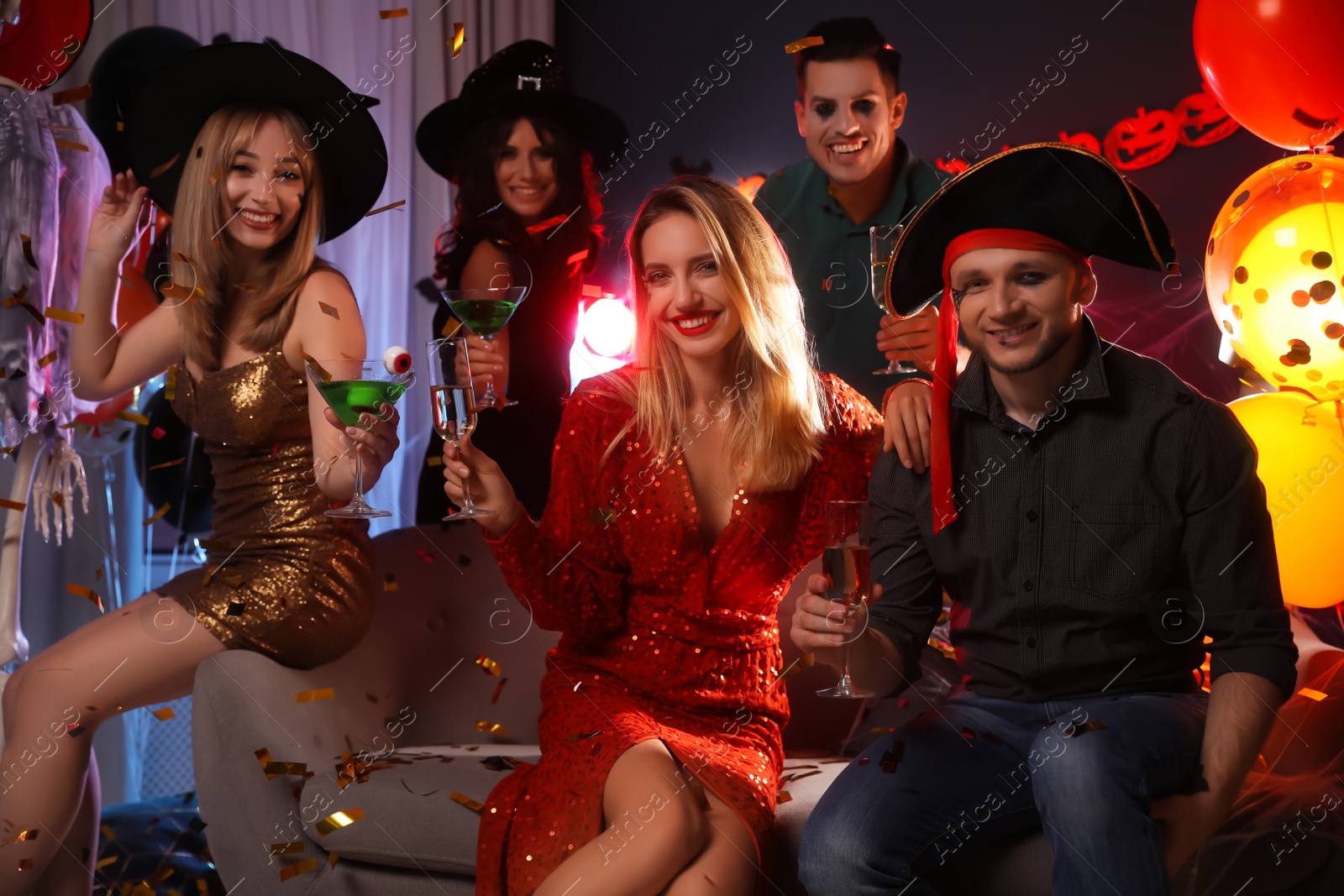 Photo of Group of friends having Halloween party at home