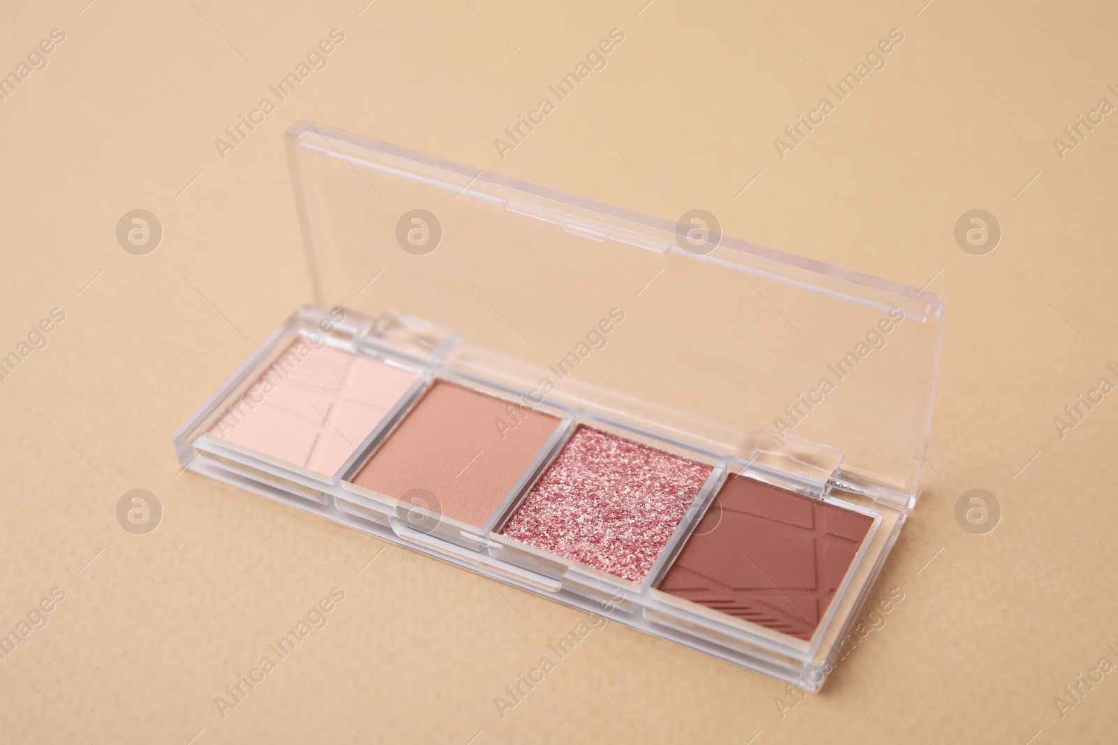 Photo of Beautiful eye shadow palette on beige background