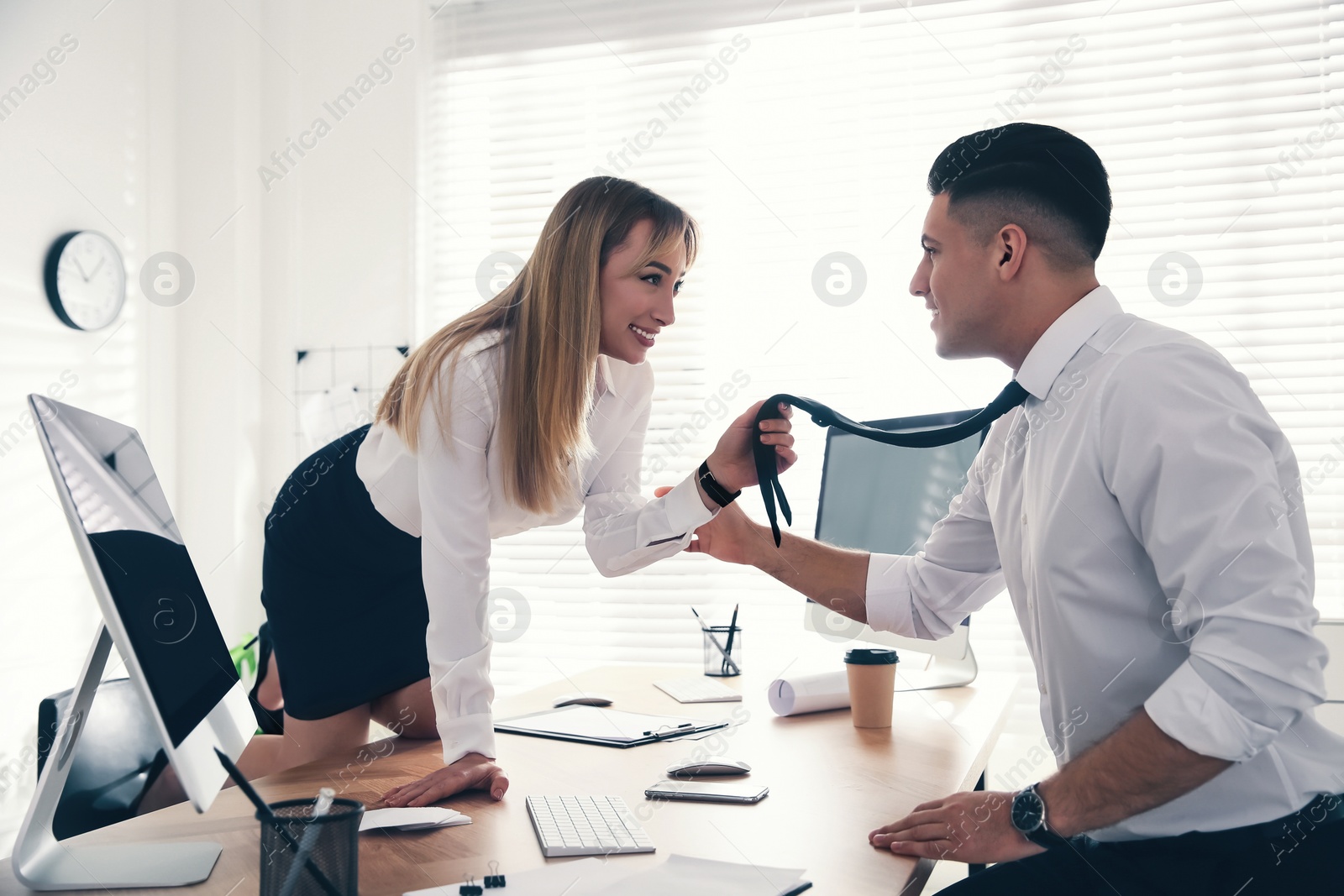 Photo of Colleagues flirting with each other during work in office