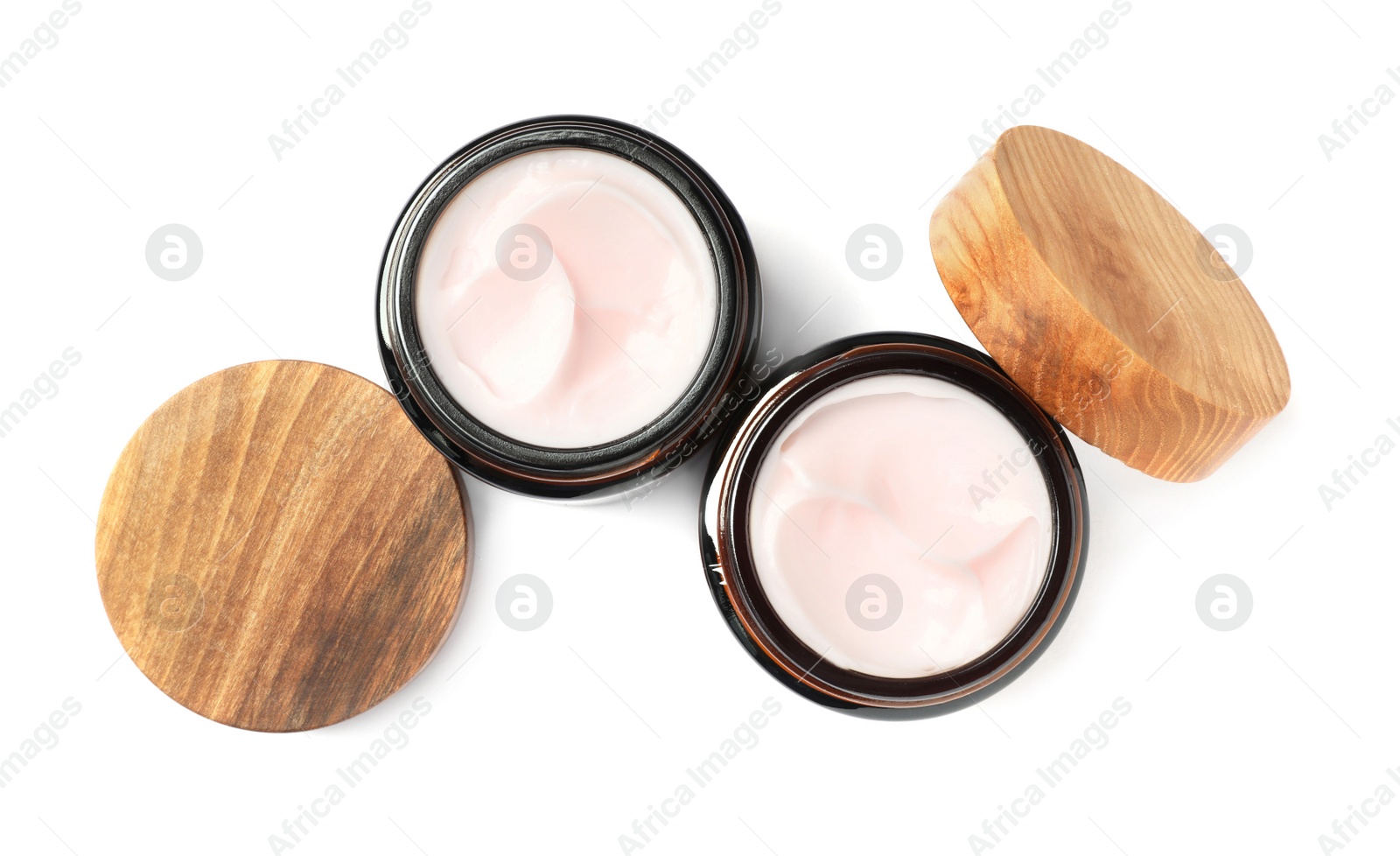 Photo of Jars of face cream isolated on white, top view