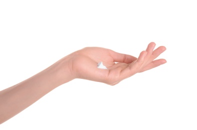 Young woman applying hand cream against on white background