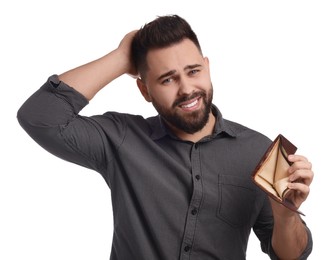 Confused man showing empty wallet on white background