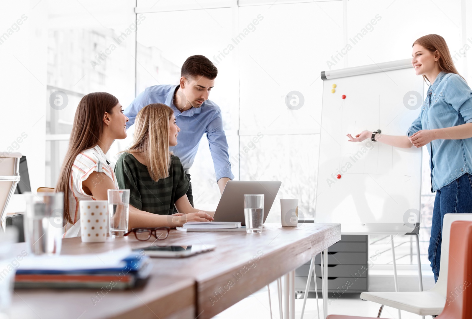 Photo of Female business trainer giving lecture in office