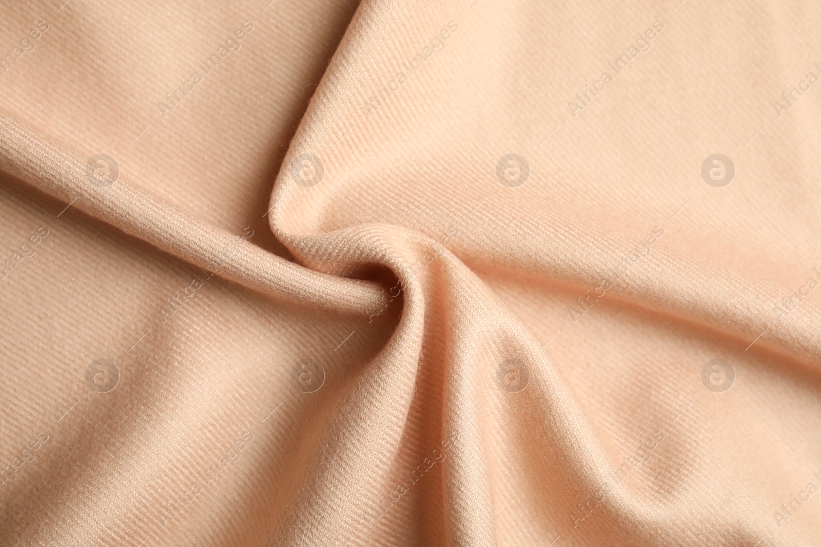 Photo of Beige soft cashmere fabric as background, closeup