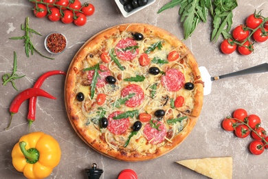 Photo of Delicious pizza with tomatoes and sausage on table, top view