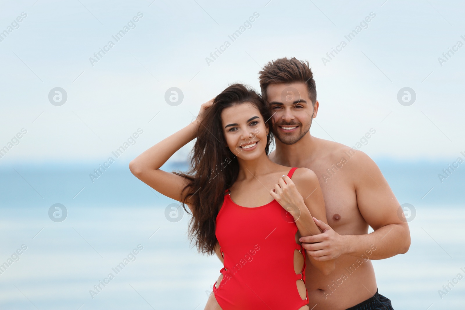 Photo of Happy young couple spending time together on beach