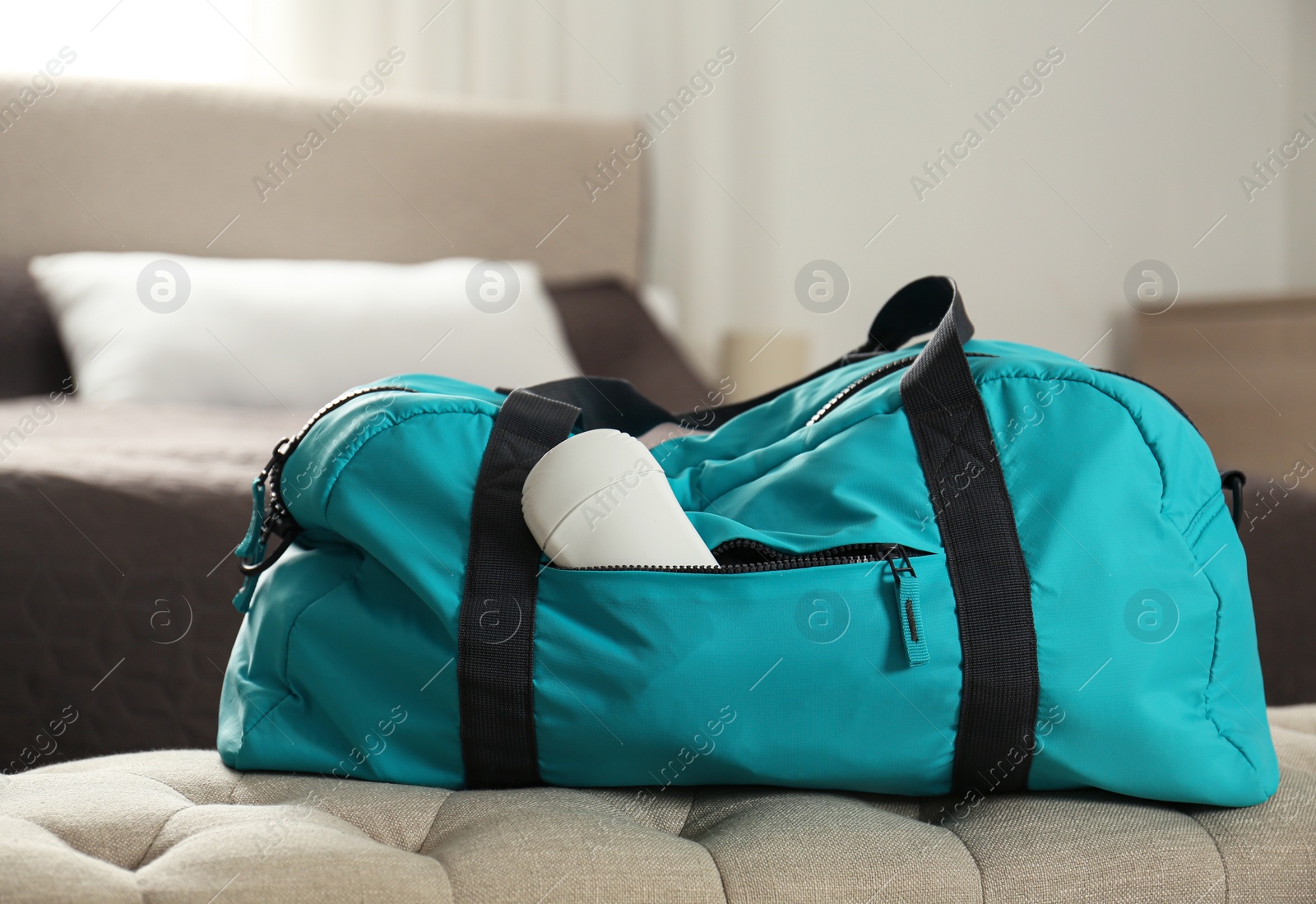 Photo of Packed gym bag with deodorant in bedroom