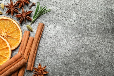 Photo of Different mulled wine ingredients on grey table, flat lay. Space for text