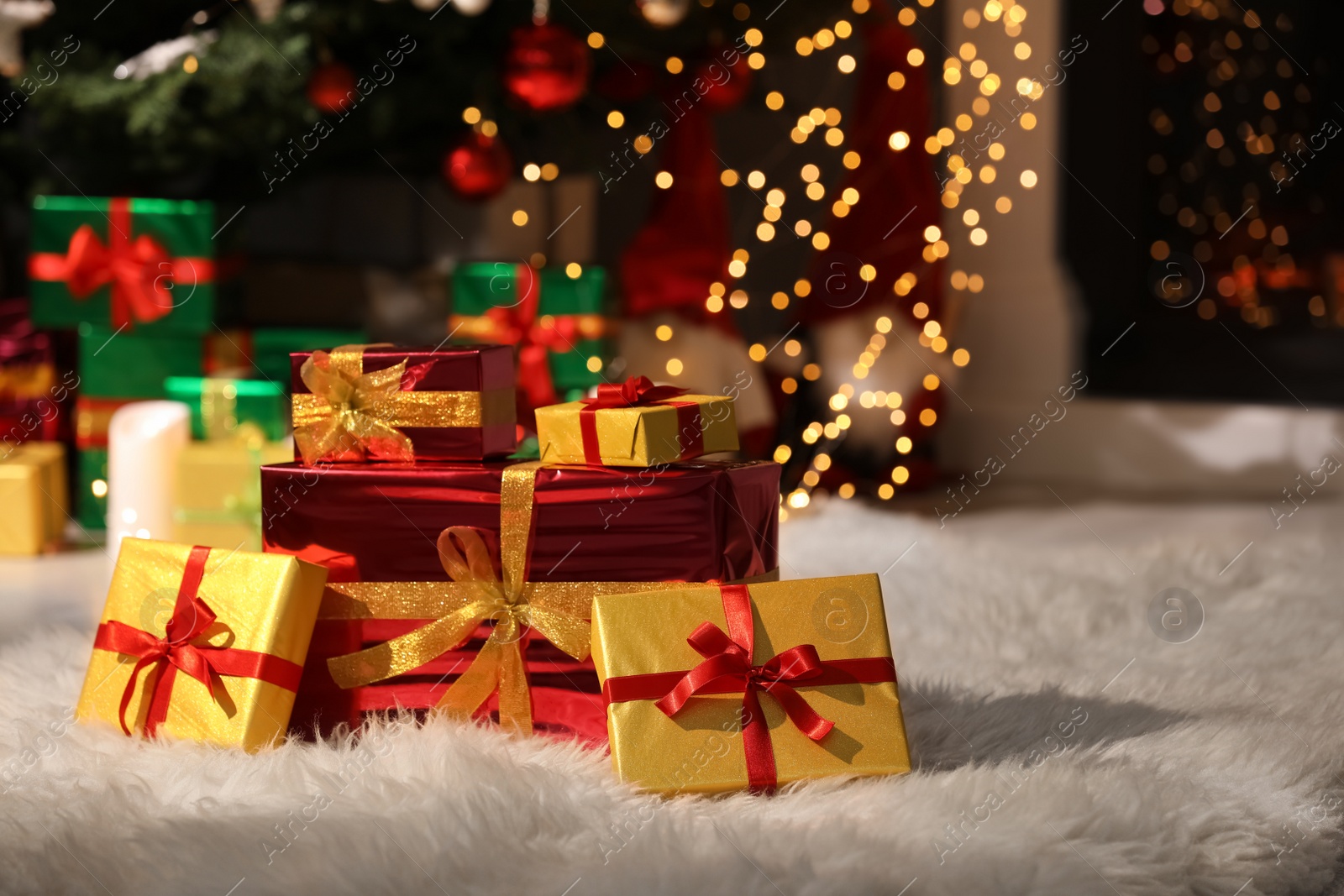 Photo of Beautiful Christmas gifts on furry carpet in room, space for text