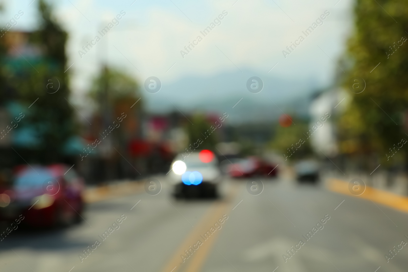 Photo of Blurred view of city street with cars