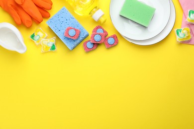 Photo of Flat lay composition with dishwasher detergent pods and tablets on yellow background, space for text