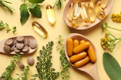 Photo of Different pills and herbs on pale orange background, flat lay. Dietary supplements