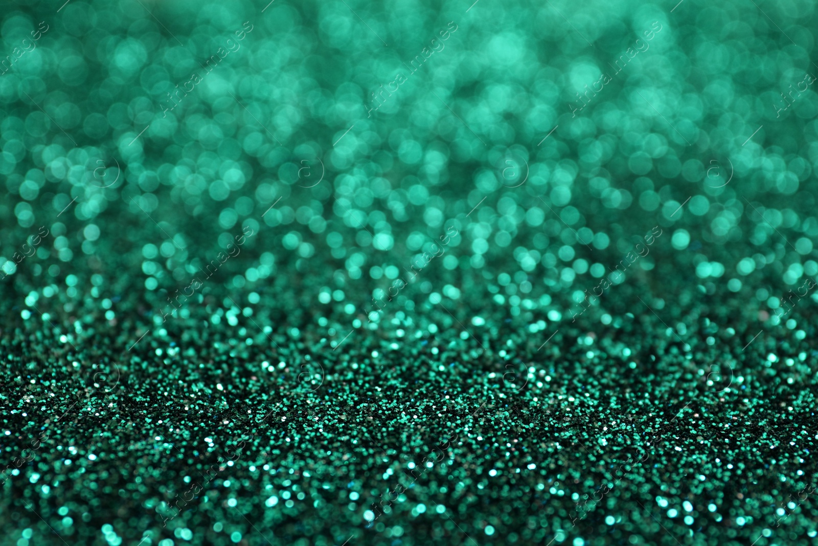 Photo of Shiny green glitter as background. Bokeh effect