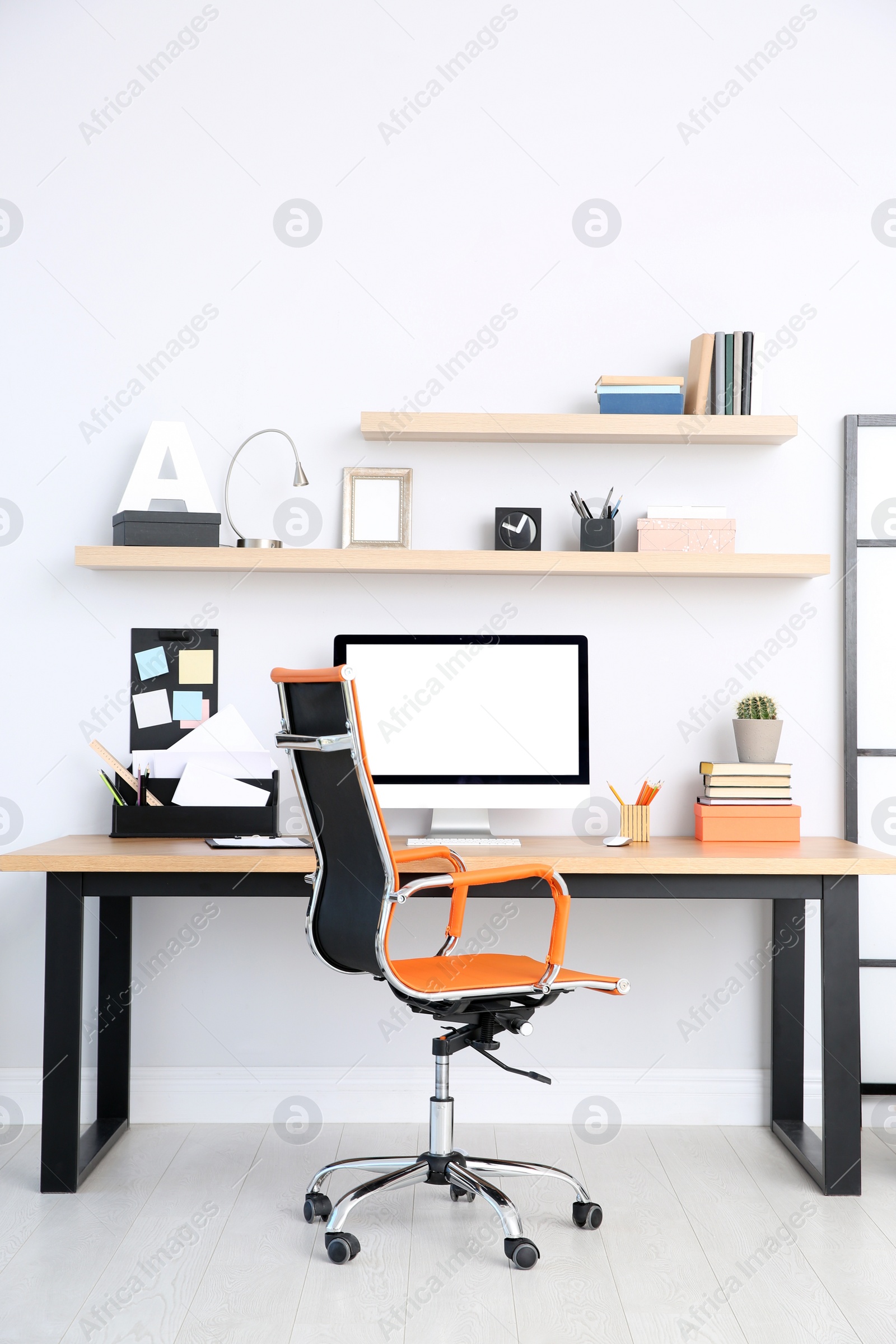 Photo of Modern computer on table in office interior. Stylish workplace