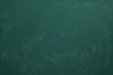 Photo of Dirty green chalkboard as background. School equipment