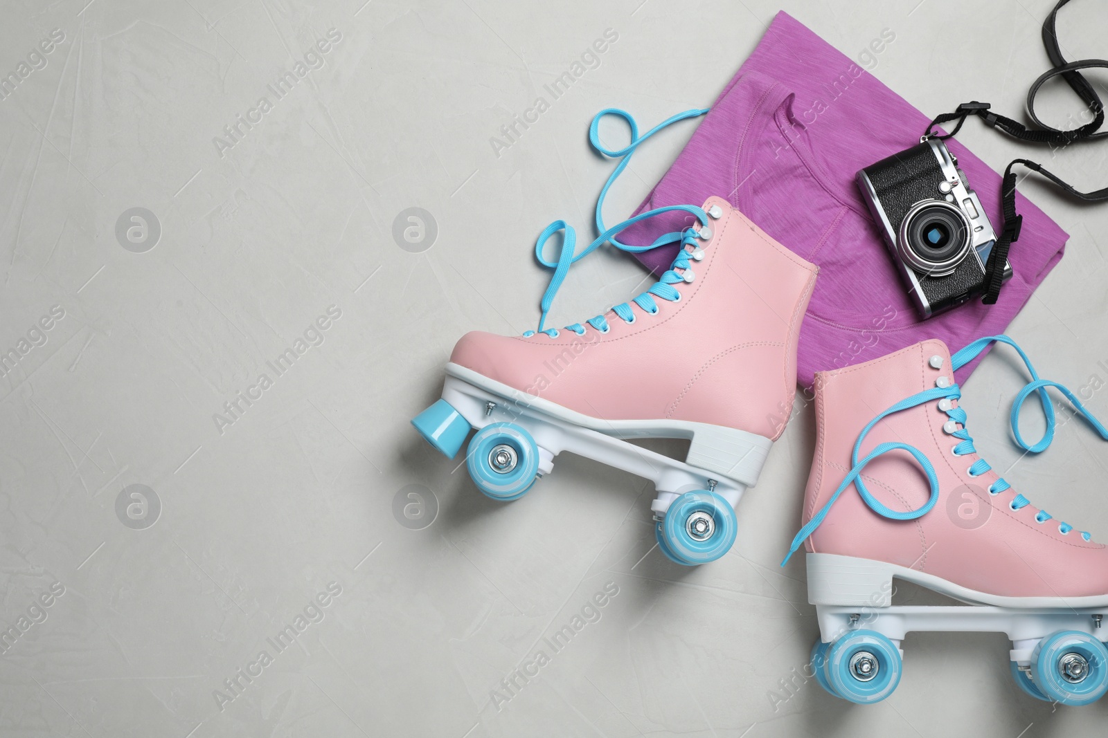 Photo of Flat lay composition with quad roller skates and space for text on light background