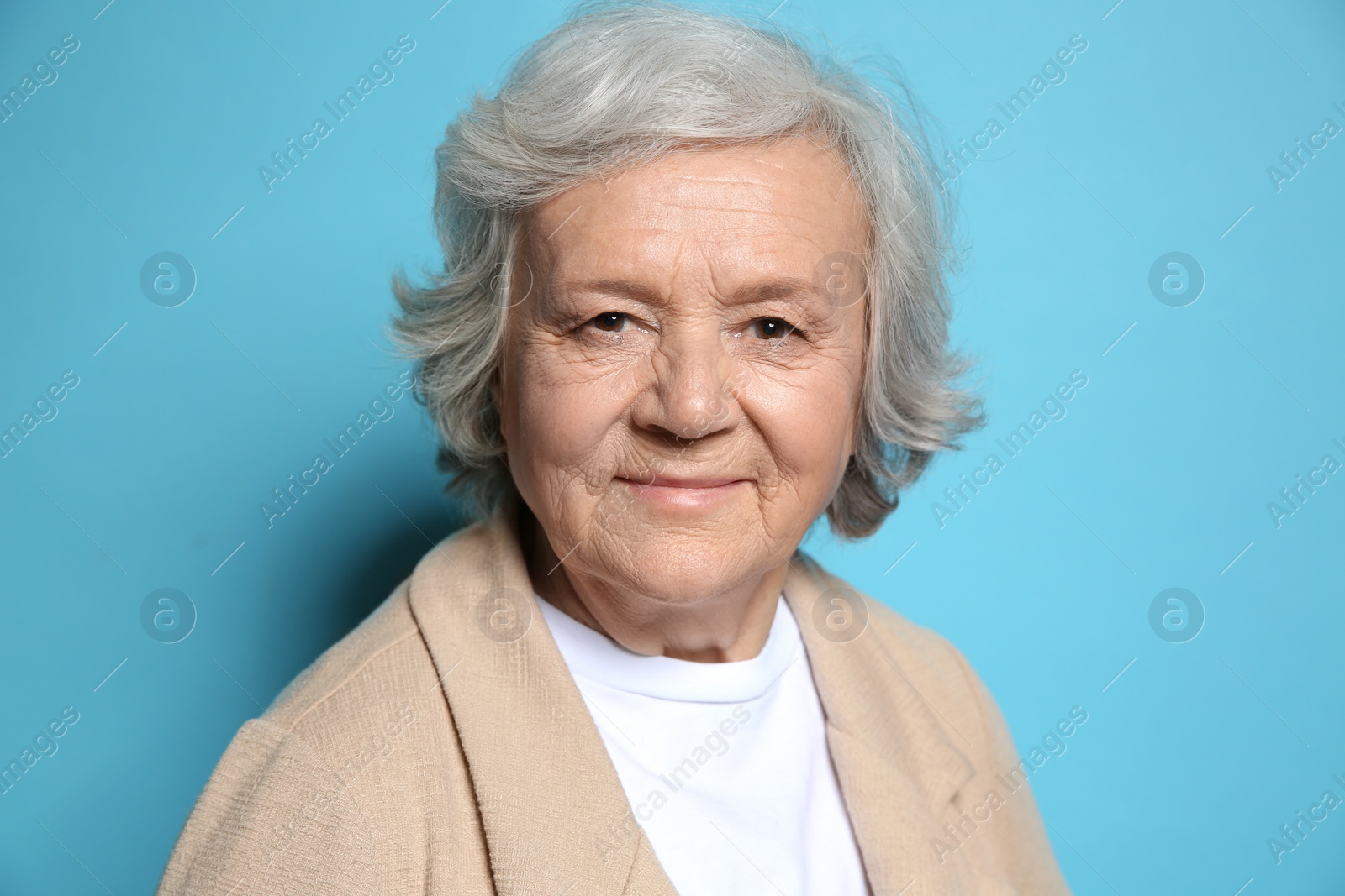 Photo of Portrait of elderly woman on color background