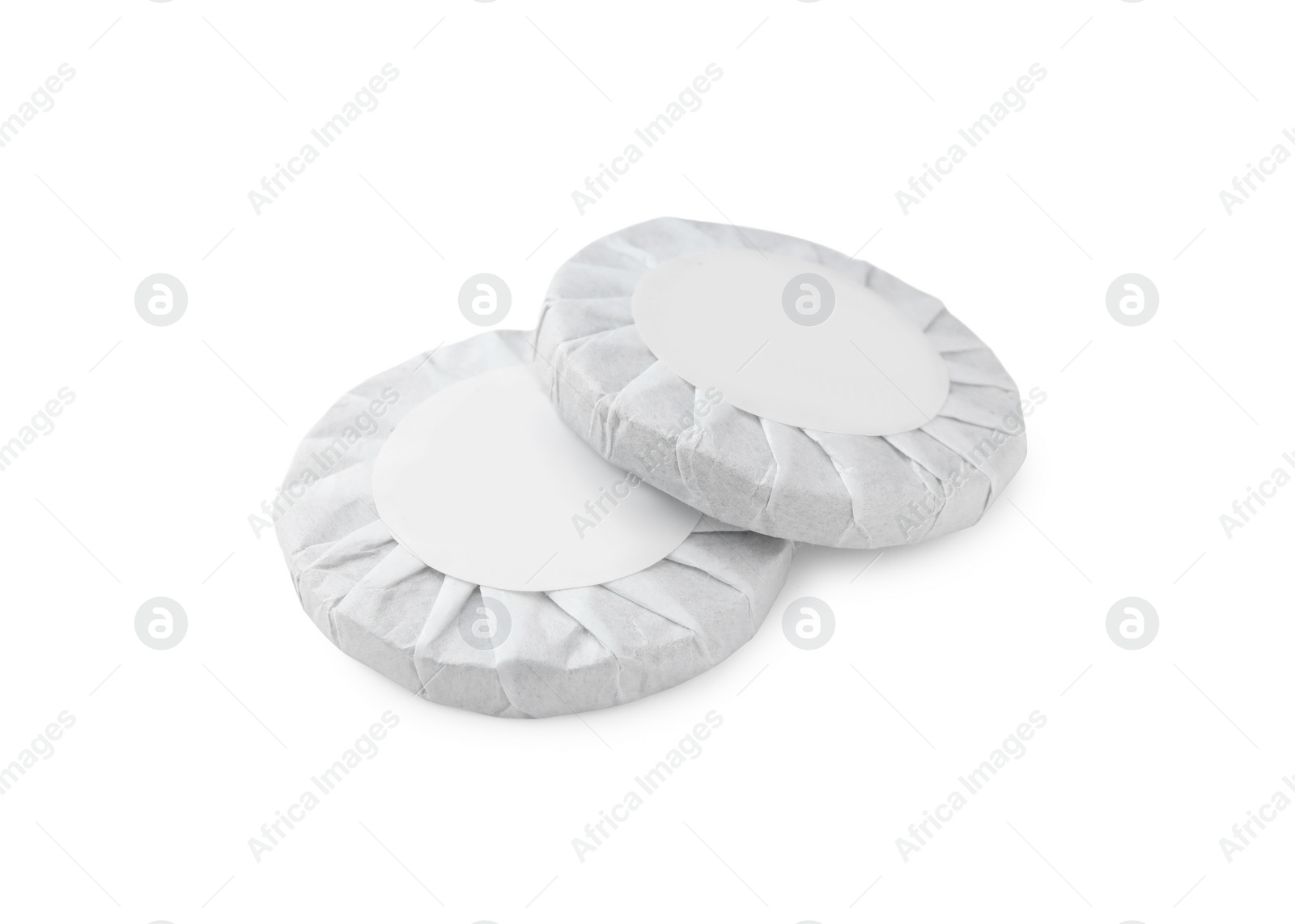 Photo of Disc shaped traditional Chinese pu-erh tea in paper wrap isolated on white