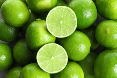 Photo of Fresh ripe green limes as background