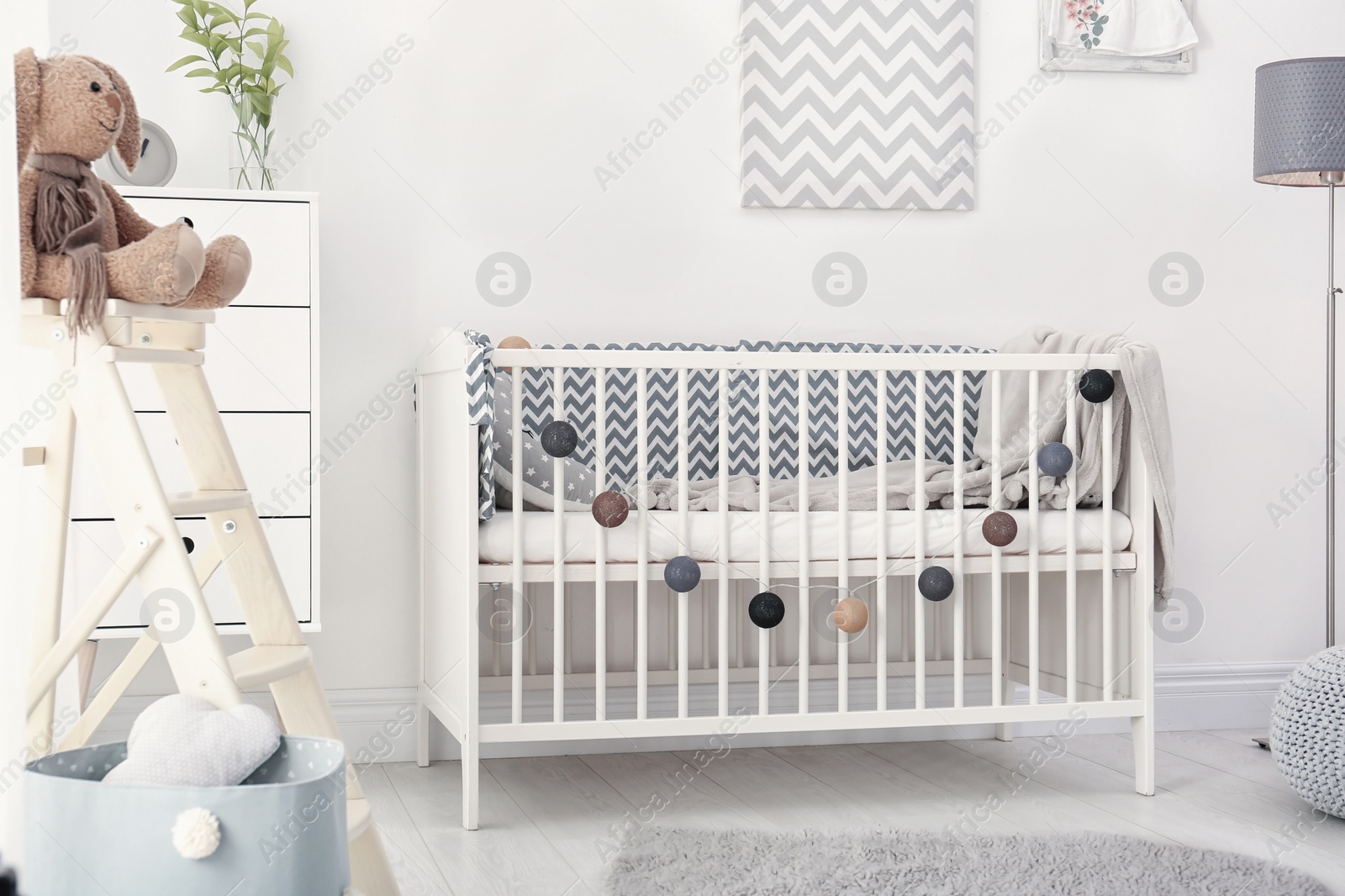 Photo of Baby room interior with comfortable crib