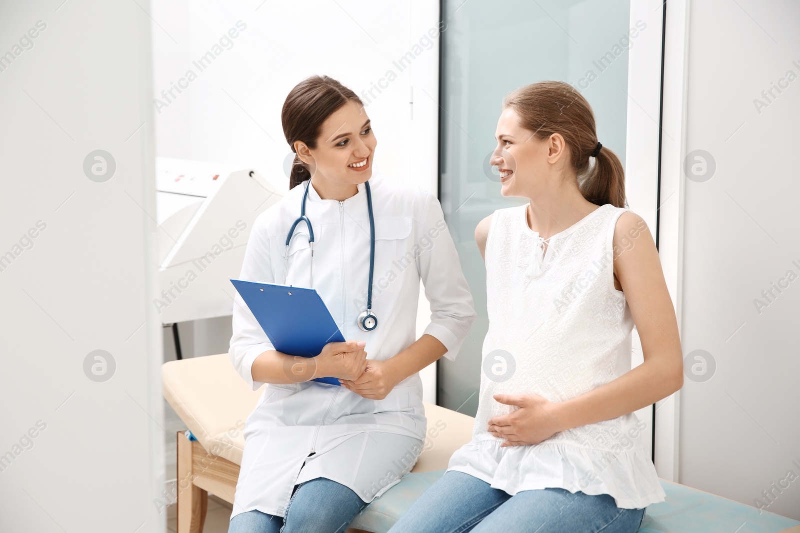 Photo of Pregnant woman having appointment at gynecologist office