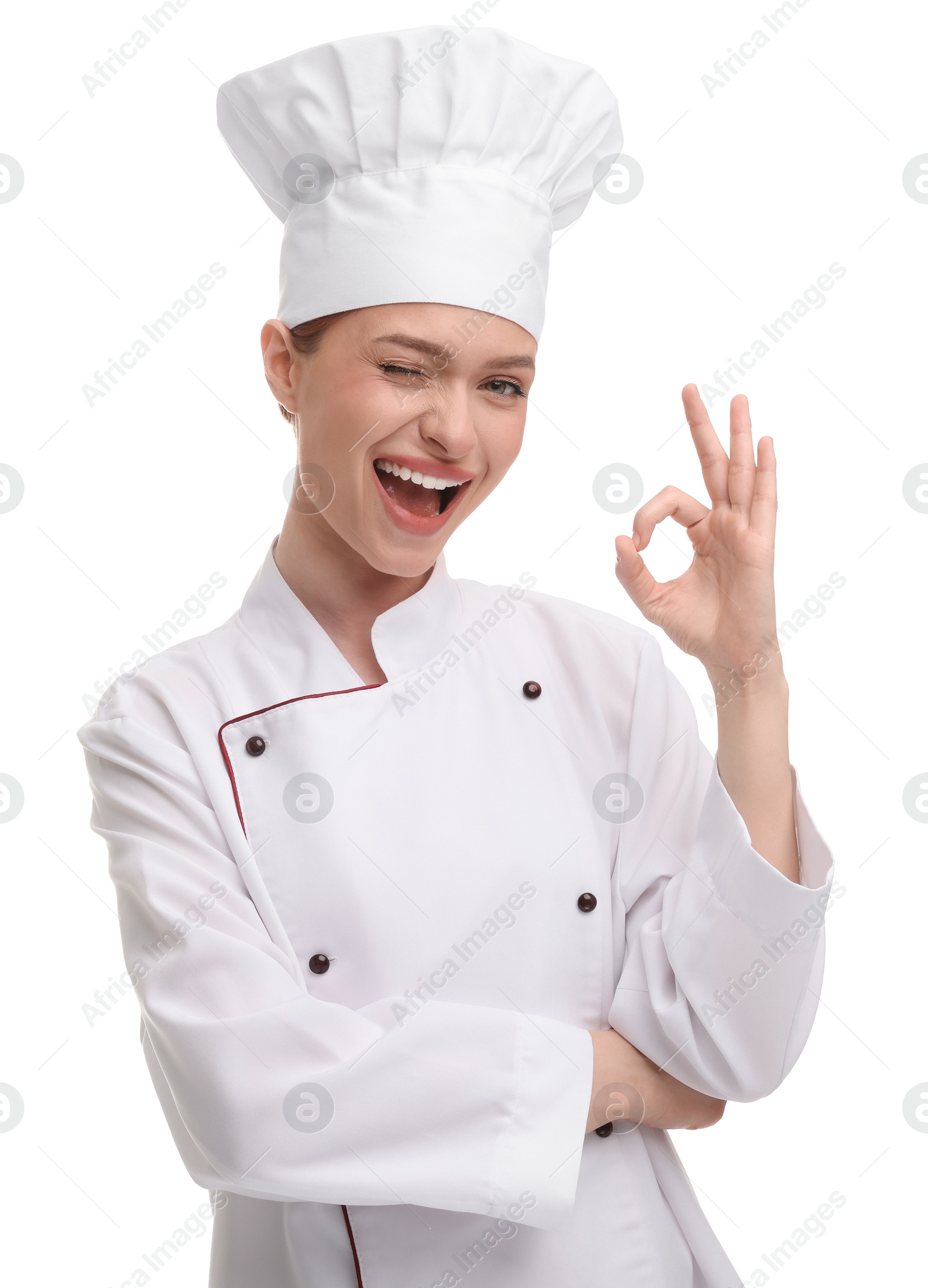 Photo of Happy woman chef in uniform showing OK gesture on white background