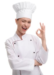 Photo of Happy woman chef in uniform showing OK gesture on white background