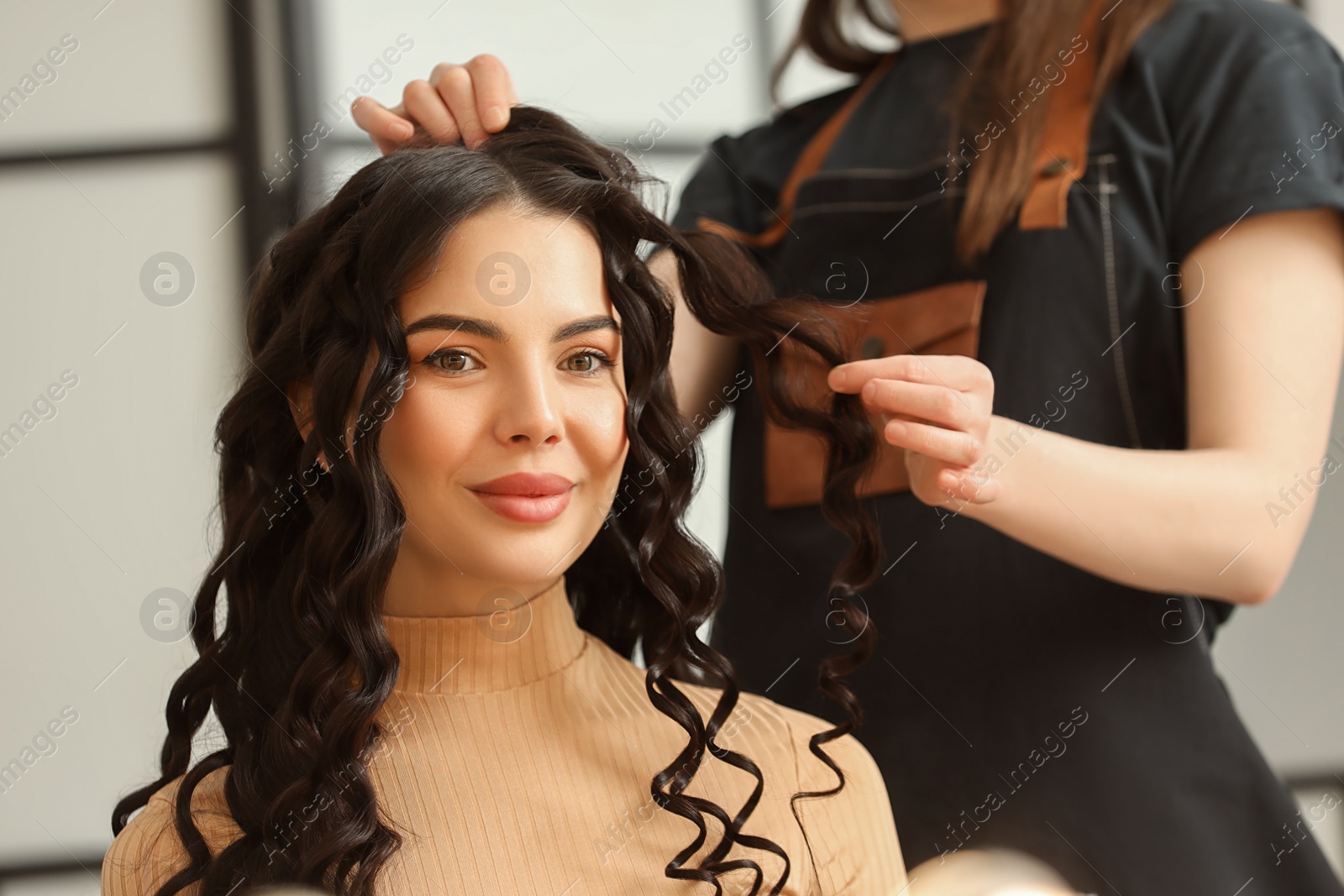 Photo of Hair styling. Professional hairdresser working with client indoors, closeup