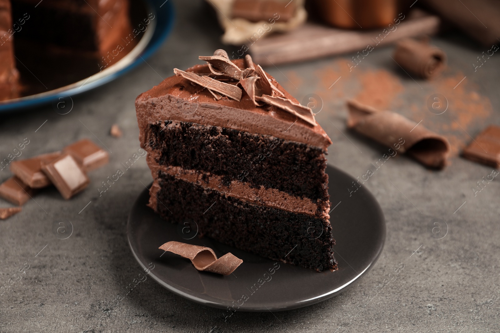 Photo of Plate with slice of tasty homemade chocolate cake on table