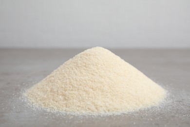 Photo of Pile of gelatin powder on grey table