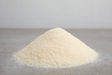 Pile of gelatin powder on grey table