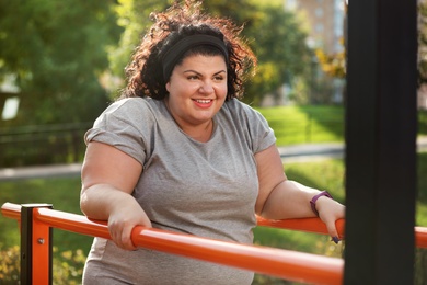 Photo of Beautiful overweight woman training on sports ground