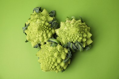 Fresh Romanesco broccoli on green background, flat lay