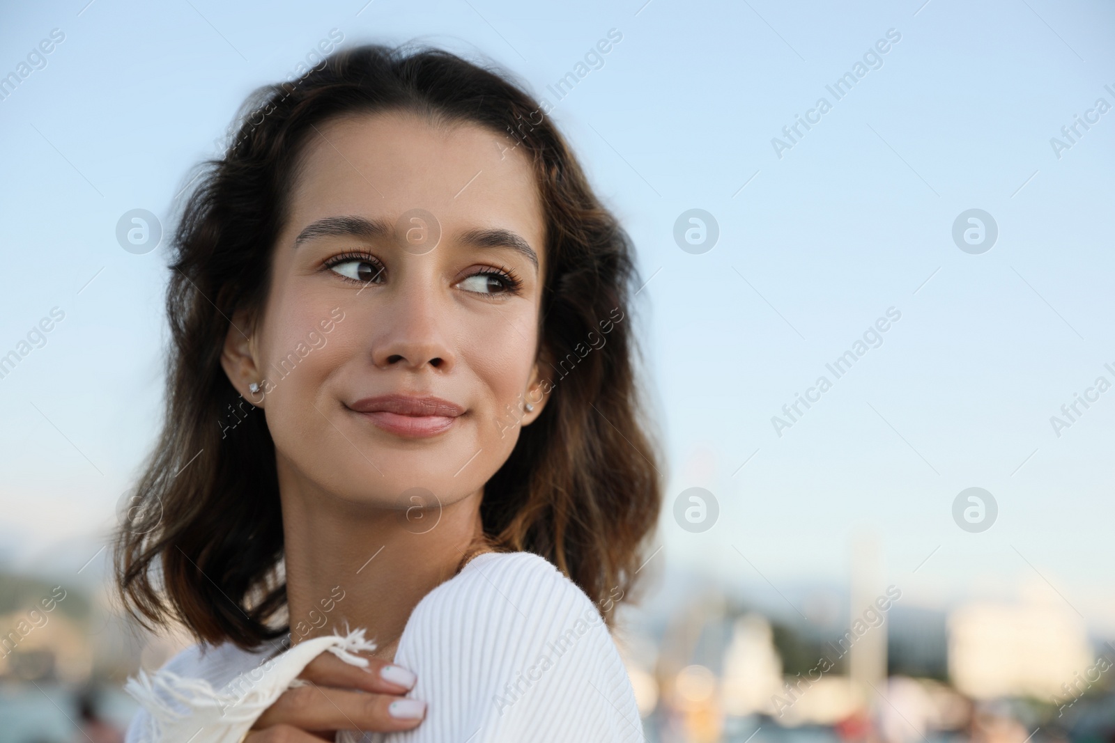 Photo of Portrait of beautiful young woman against blue sky. Space for text