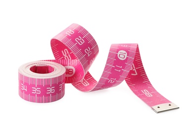 Photo of New pink measuring tape isolated on white