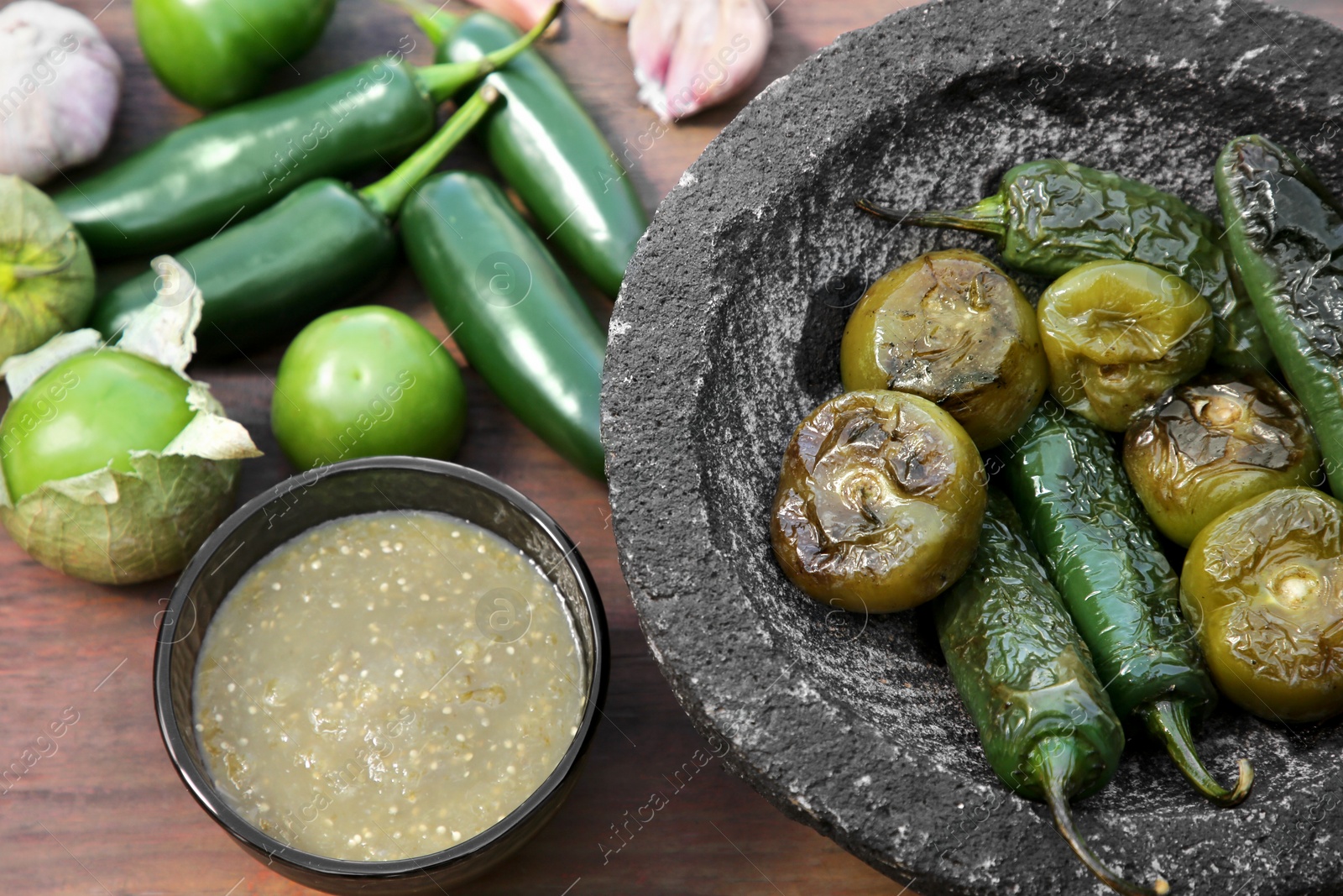 Photo of Different ingredients for cooking tasty salsa sauce on wooden table, above view