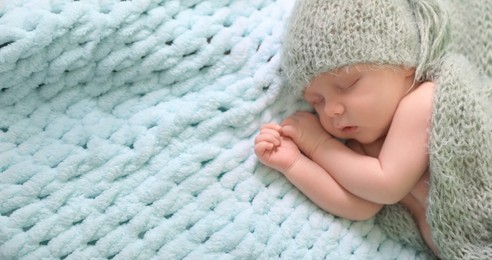 Image of Cute baby baby sleeping on light blue blanket, top view. Banner design with space for text