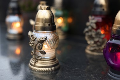 Photo of Grave lights on granite surface at cemetery