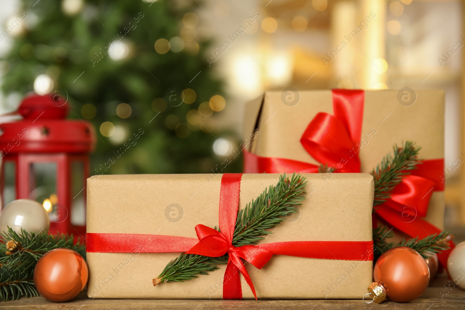 Photo of Beautiful gift boxes and Christmas decor on wooden table, closeup