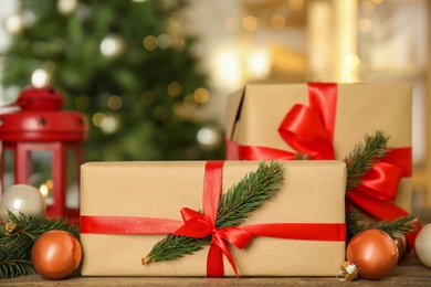 Photo of Beautiful gift boxes and Christmas decor on wooden table, closeup